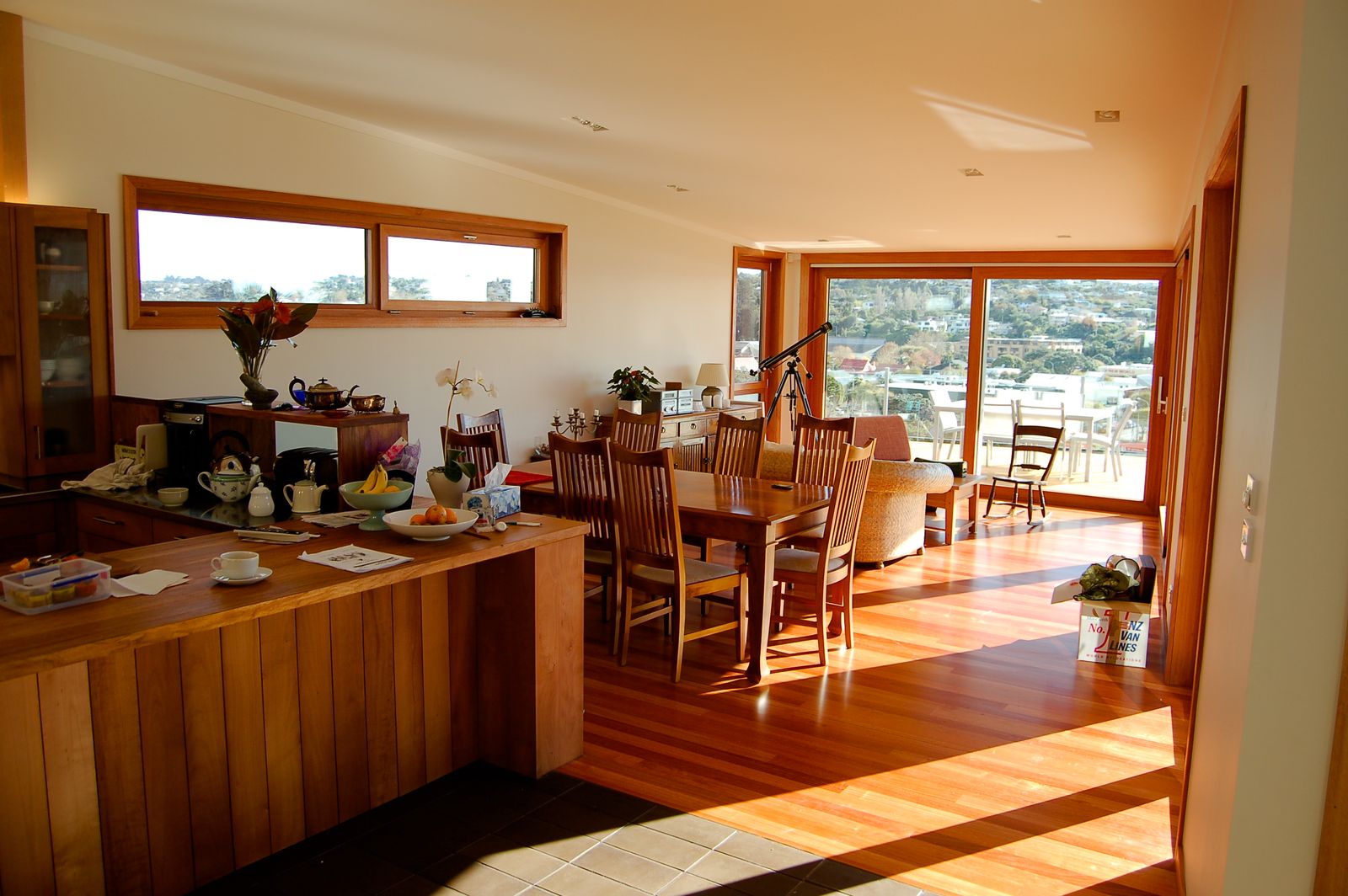 Open plan kitchen, dining and living with timber floors and views