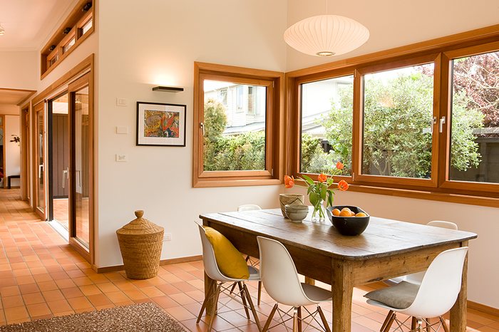 Dining area with corner windows in timber joinery